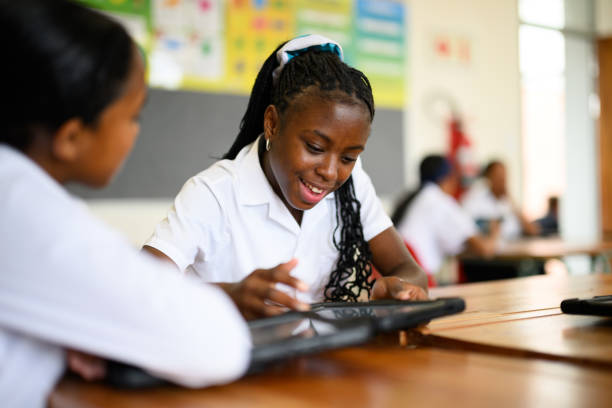 multiracial schoolgirls using digital tablet in mathematics class